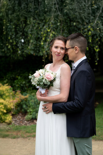 Portrait romantique des mariés enlacés dans un décor naturel